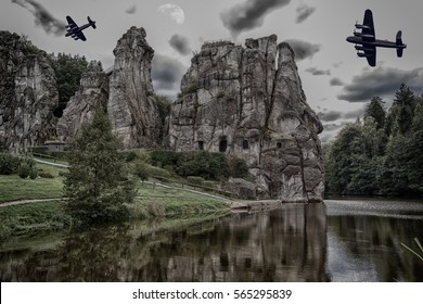 Two Old Combat Aircraft, Bomber From The World War II Flying Over The Externsteine. Rock Formation In The Teutoburg Forest, Germany, North Rhine Westphalia.