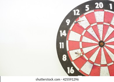 Two Old Darts On An Old Dart Board With Many Holes. Concept Of Competition; Failed Attempt (missed Target); No Skill; Or No Improvement. White Background And Copy Space On The Left.