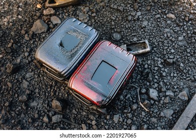 Two Old Dirty Canisters With Oil, Diesel, Gasoline, Oil, Smeared With Fuel Oil, Grease, Lie Against The Background Of Black Graphite, Coal In A Landfill. Photo, Top View.