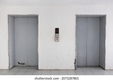 Two Old Elevator Doors On A White Wall