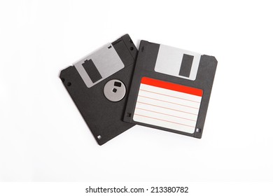 two old floppy discs with white an red label, front an background 