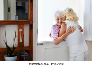 Two Old Friends Hugging Each Other At The Door After A Great Visit