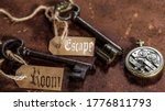 two old keys on a rusty metal table with labels : escape room
