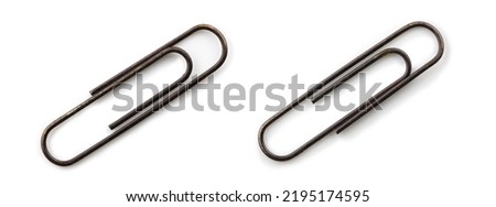 Two old paper clips, isolated on white, with natural shadows. Old rusted paper clips. 