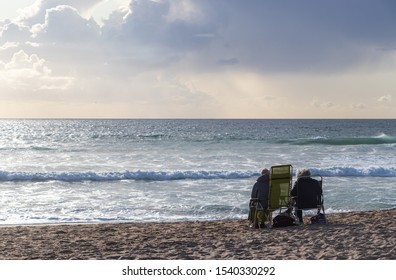 Two old people by the sea