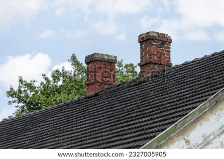 Two old red brick chimneys.