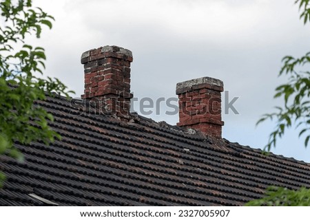 Two old red brick chimneys.
