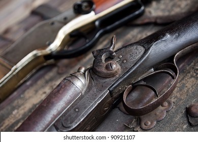 Two Old Rifles Sit On A Table