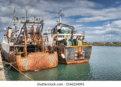 Two Old And Rusty Fishing Boats Moored In Howth Harbour. Phishing And Shellfish Fishing Equipment On Fishing Boats, Dublin, Ireland