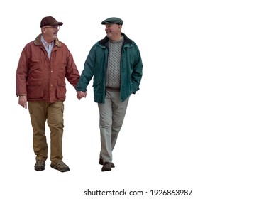 Two older gay men hold hands while walking.  Isolated on a white background.