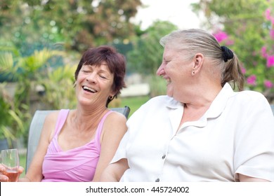 Two older women laughing having fun outdoors
