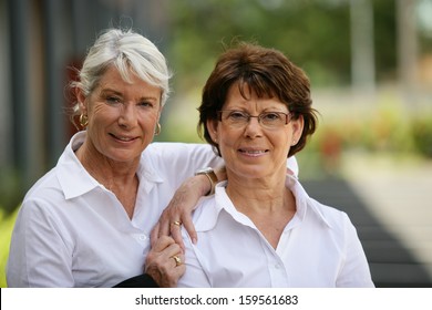 Two Older Women Standing Outside