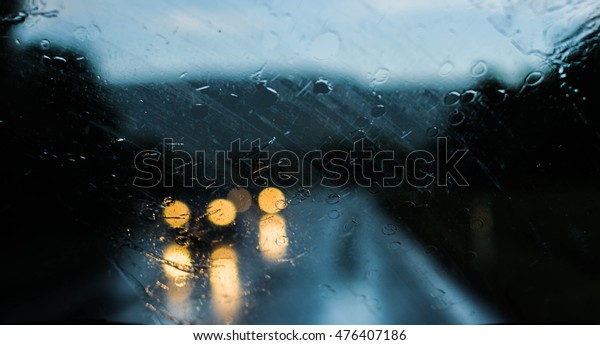 Two Oncoming Cars in the Rain - View\
through the Front Window of Car - On the Road -\
Blur
