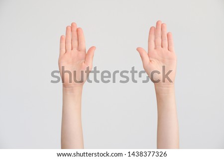 Two opened child's handbreadths on a neutral background