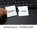 Two opposite words strategy and tactics. Strategy is the overarching plan or overarching goal, while tactics are the specific actions or methods used to achieve that strategy