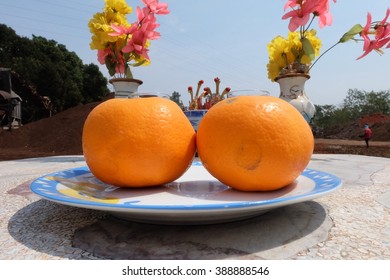 Two orange in a dish.