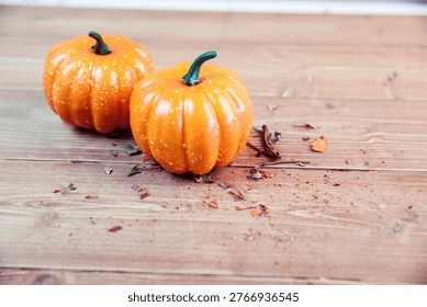 Two orange pumpkins on table during Thanksgiving time