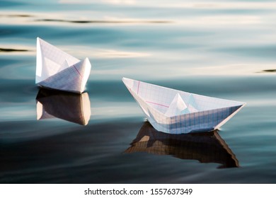 Two Origami Paper Boats Floating 