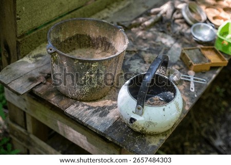 Two outdoor rustic cooking pans to use for a play kitchen set