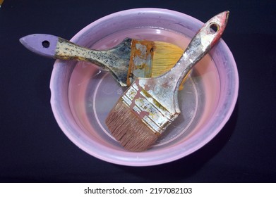 two paint brushes soaked in water so they don't harden - Powered by Shutterstock