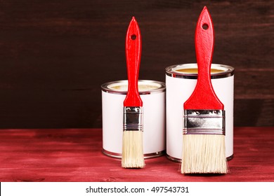 Two Paint Cans With Brushes, Lacquer Or Varnishing Wooden Floor.