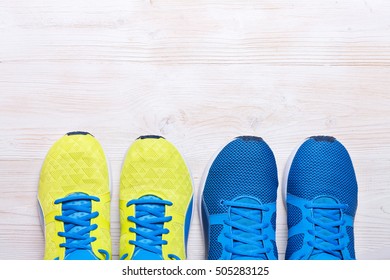 Two Pair Of Blue And Yellow Sport Shoes On White Background
