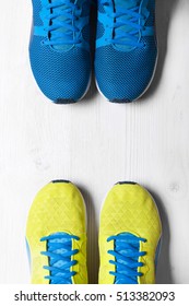 Two Pair Of Blue And Yellow Sport Shoes On White Background
