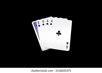Two pair of eights and aces  with one overturned card. "Dead Man's Hand" poker hand isolated on black background