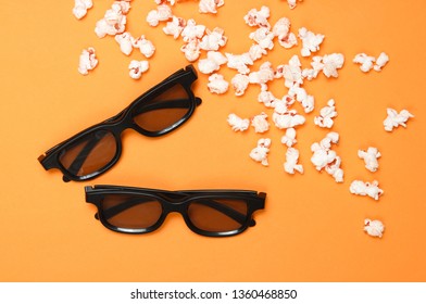 Two Pairs 3D Glasses, Popcorn On Orange Background. Top View, Flat Lay