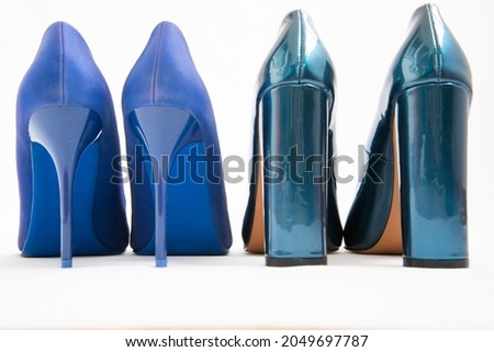 Two pairs of blue women's shoes. High-heeled shoes. One pair of thin heels, stiletto heels. The second pair has a stable wide heel. Fashionable stylish shoes