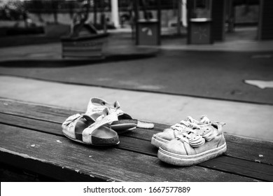 Two Pairs Of Childrens Shoes Left Behind At A Playground