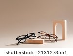 Two pairs of eyelass frames on beige background. Minimalism, summer fashion concept. Trendy eyeglasses still life in minimal stile. Optic store discount, sale. Copy space for text