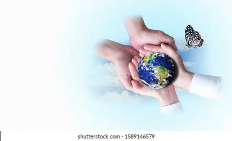 Two Pairs Of Hands Helping To Support The Globe With Butterflies On A Blue And White Background. Safe World And Ecology Concept. Elements Of This Image Furnished By NASA