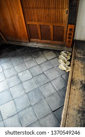 Two Pairs Of Japanese Geta Sandals At An Entrance (Tranlsation: Technically 