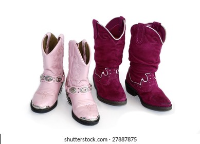 Two pairs of pink cowgirl boots on white background.