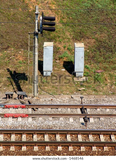 Two pairs of rails and a\
signal post