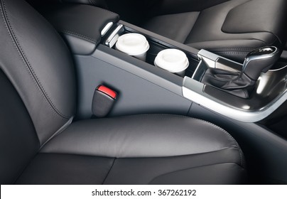 Two Paper Coffee Cups Standing Inside The Car Holder Between Seats