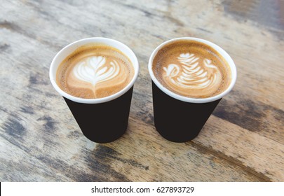 Two paper cups of coffee ,latte art and cappuccino takeaway