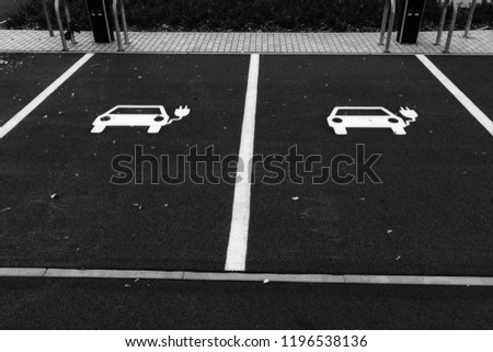 Two parking spaces for electric cars in black and white