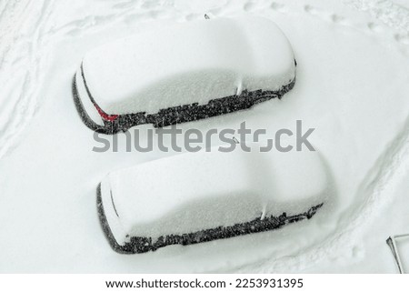 Two passenger black cars covered with snowdrifts. car under the snow. stuck car in a snowdrift, passenger car covered with snow in winter, winter road collapse
