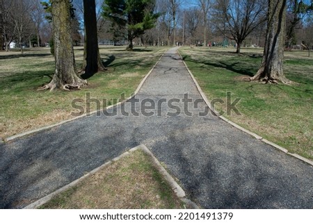 Two paths converge together or there is a fork in the path leading in different directions. A path leads through Phelps Grove Park in Springfield, Missouri. More images at OzarkStockPhotography.com