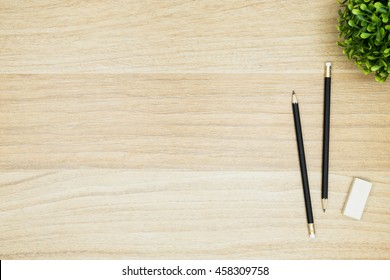 Two Pencils With Eraser Are  On Top Of Wood Desk Table. Top View With Copy Space, Flat Lay.