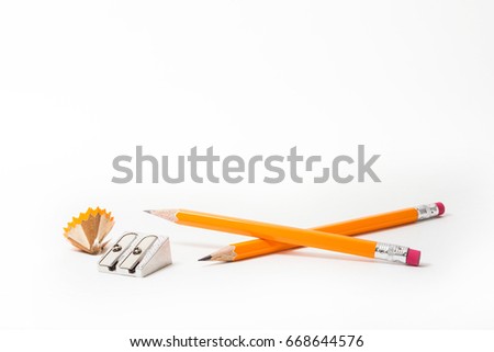 Two Pencils with pencil sharpener and sharpening shavings on white background. stationery. Office tool.