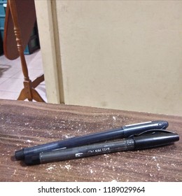 two pens on a table