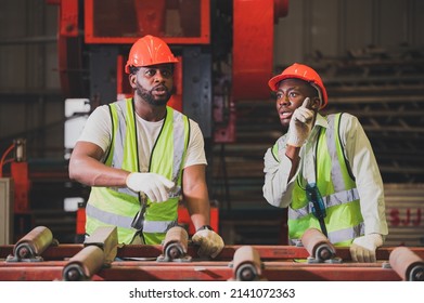 Two People Black Man African American Worker Control Heavy Machine In The Factory.