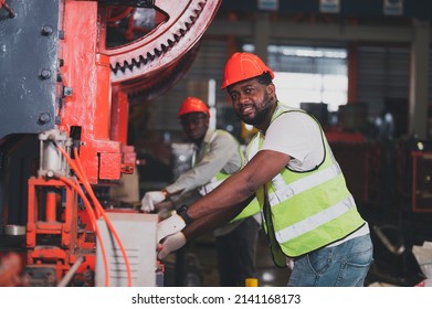 Two People Black Man African American Worker Control Heavy Machine In The Factory.