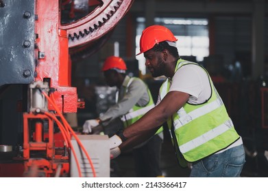 Two People Black Man African American Worker Control Heavy Machine In The Factory.