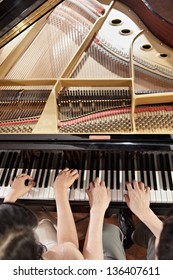 Two People, A Couple Playing Piano Duet, Showing Mostly Their Hands