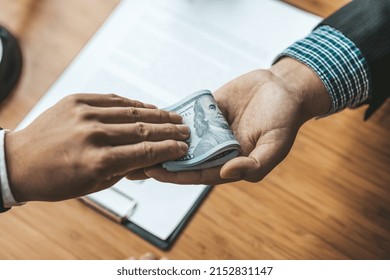 Two people are doing corrupt behavior, they are mutual business partners and are signing contracts to receive bribes for mutual benefit. The concept of business fraud and bribery is illegal.
