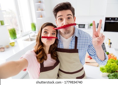 Two People Dream Comic Humor Joking Couple Lovers Have Fake Mustache Red Hot Chilli Pepper Make Selfie Show V-sign Enjoy Healthy Weekend Lifestyle Prepare Nutrition In Kitchen House Indoors